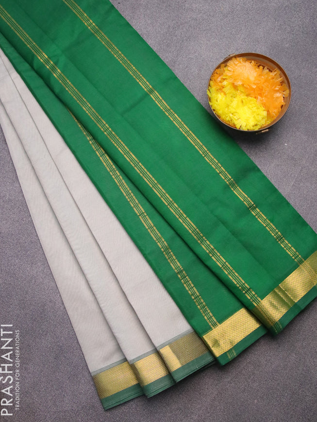 Silk cotton saree grey and green with plain body and zari woven border