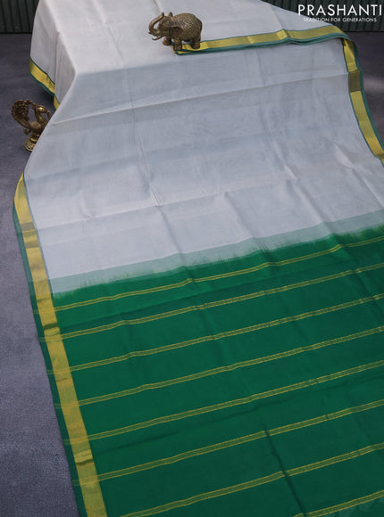 Silk cotton saree grey and green with plain body and zari woven border