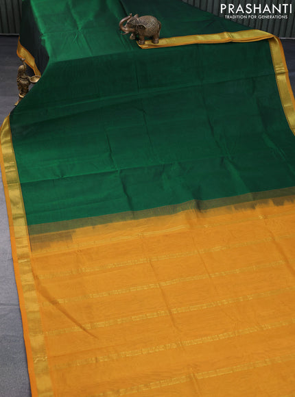 Silk cotton saree dark green and mustard yellow with plain body and zari woven border