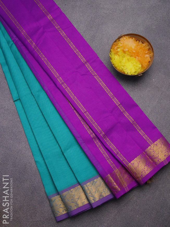 Silk cotton saree teal blue and purple with plain body and peacock zari woven border