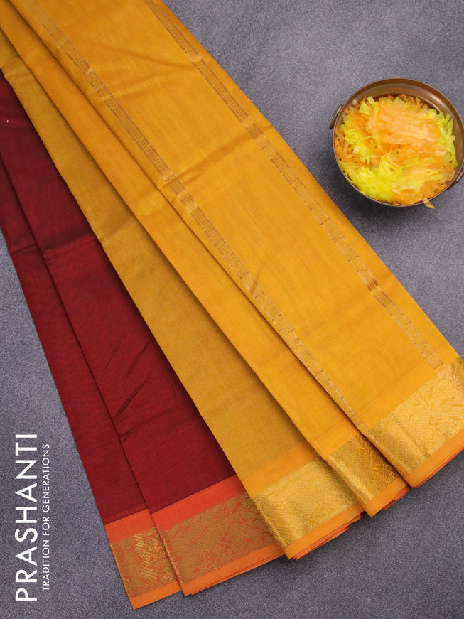 Silk cotton saree maroon and mustard yellow with plain body and peacock zari woven border