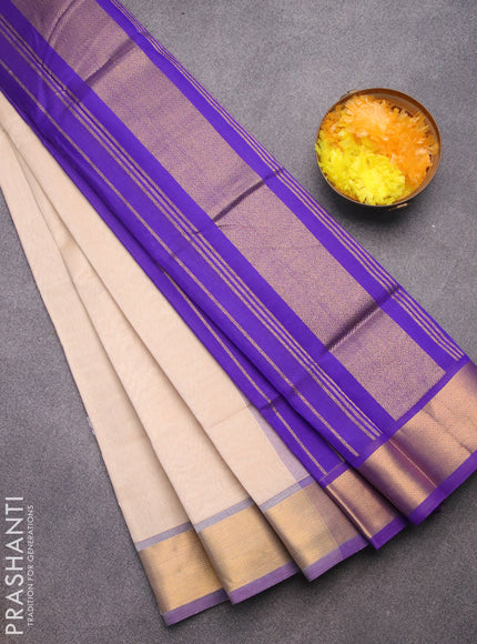 Silk cotton saree cream and blue with plain body and zari woven border