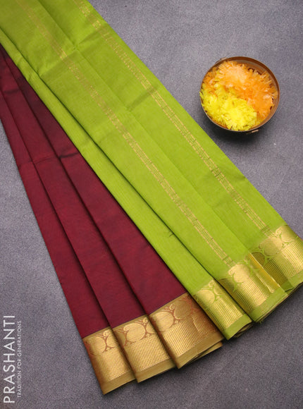 Silk cotton saree deep maroon and light green with plain body and paisley zari woven border