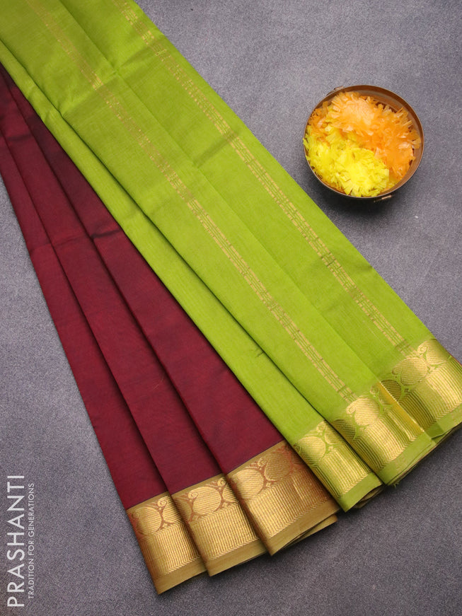 Silk cotton saree deep maroon and light green with plain body and paisley zari woven border