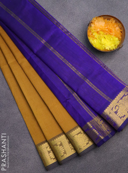 Silk cotton saree mustard shade and blue with plain body and zari woven border