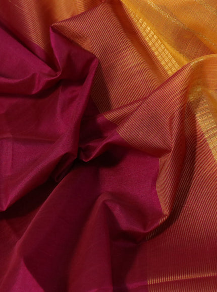 Silk cotton saree dark magenta pink and mustard yellow with plain body and zari woven border