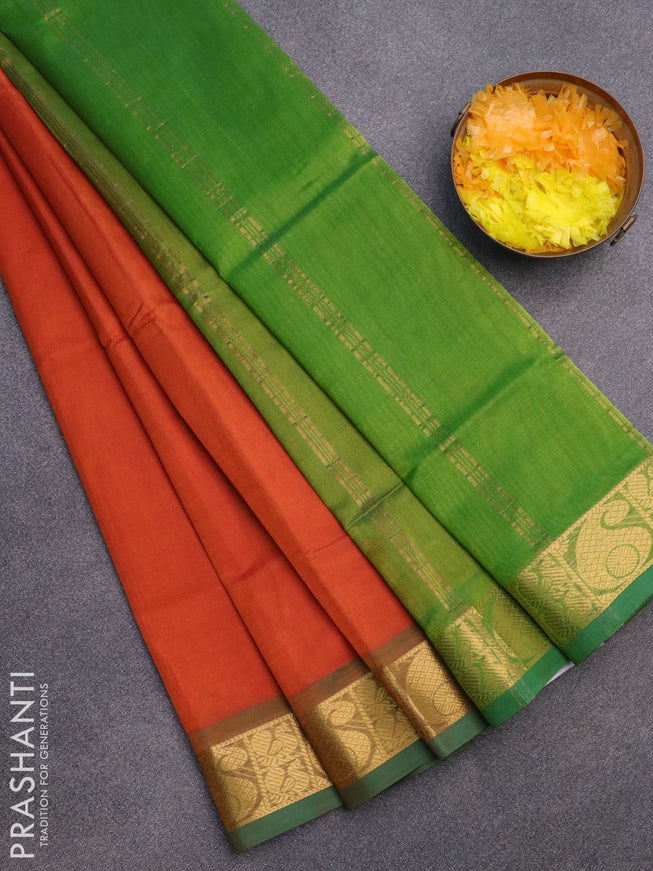 Silk cotton saree orange and light green with plain body and paisley zari woven border