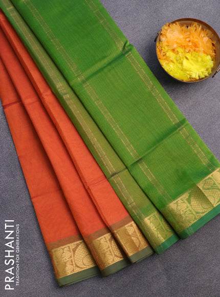 Silk cotton saree orange and light green with plain body and paisley zari woven border