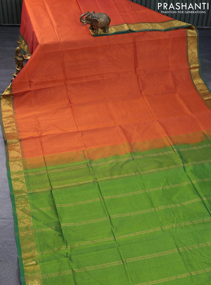 Silk cotton saree orange and light green with plain body and paisley zari woven border