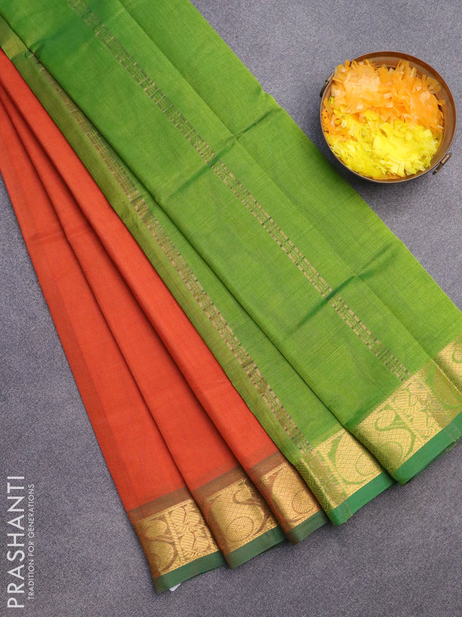 Silk cotton saree orange and green with plain body and paisley zari woven border