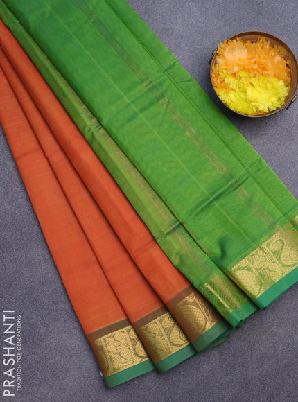 Silk cotton saree orange and green with plain body and paisley zari woven border