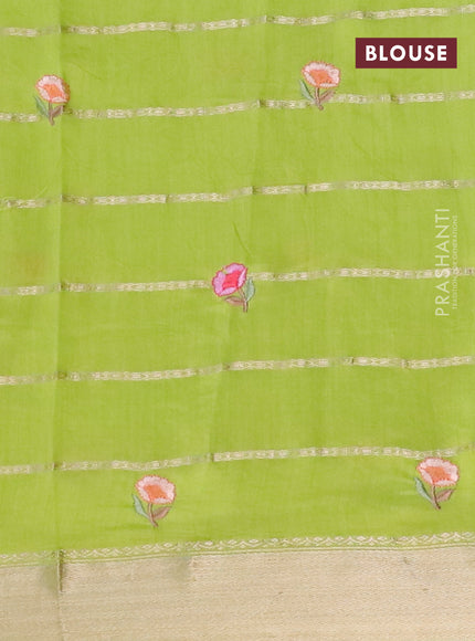 Assam silk saree fluorescent green with allover zari weaves & embroidery work buttas and floral design embroidery work zari border