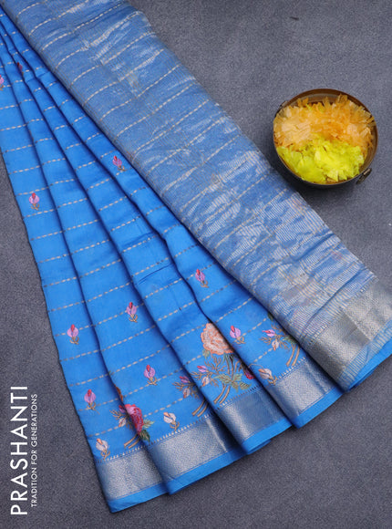 Assam silk saree cs blue with allover zari weaves & embroidery work buttas and floral design embroidery work zari border