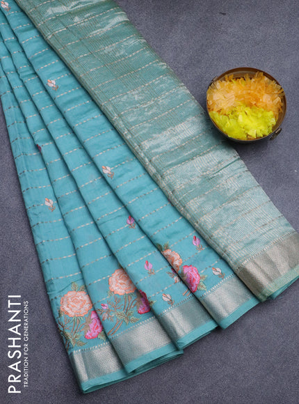 Assam silk saree teal blue shade with allover zari weaves & embroidery work buttas and floral design embroidery work zari border