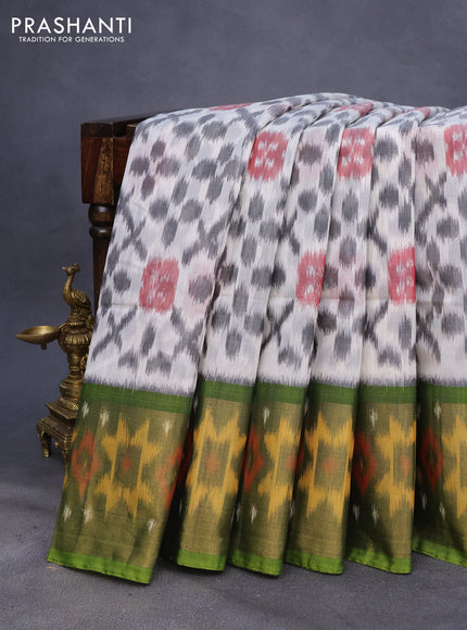 Ikat silk cotton saree off white and light green with allover ikat weaves and long ikat woven zari border