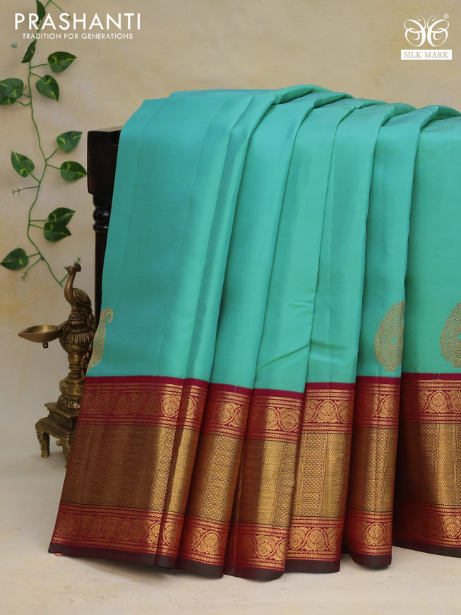 Pure kanchipuram silk saree teal blue shade and magenta pink with paisley zari woven buttas and zari woven korvai border