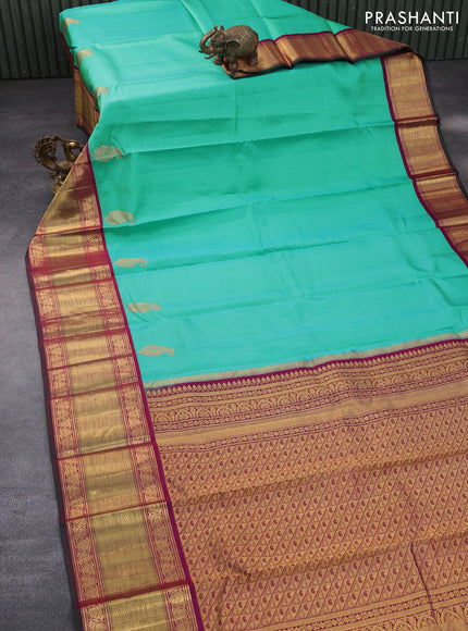 Pure kanchipuram silk saree teal blue shade and magenta pink with paisley zari woven buttas and zari woven korvai border