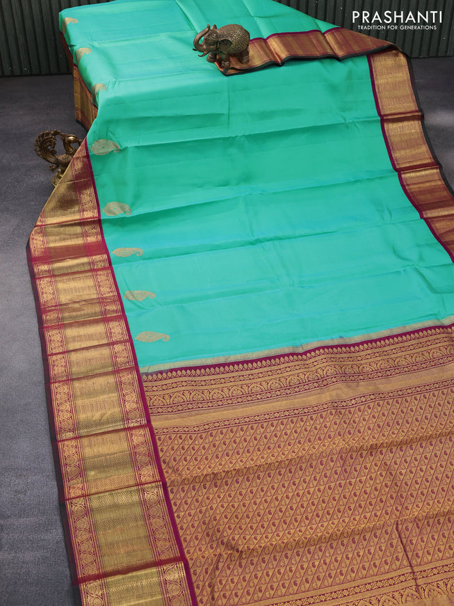 Pure kanchipuram silk saree teal blue shade and magenta pink with paisley zari woven buttas and zari woven korvai border