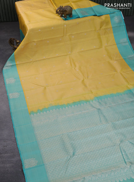 Pure kanchipuram silk saree yellow and teal blue with allover silver zari weaves and silver zari woven butta border