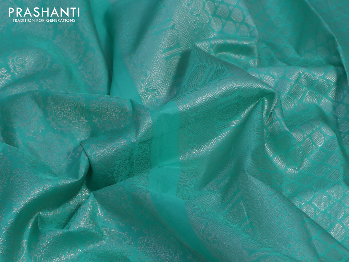 Pure kanchipuram silk saree teal blue with allover silver zari woven brocade weaves and long silver zari woven floral butta border