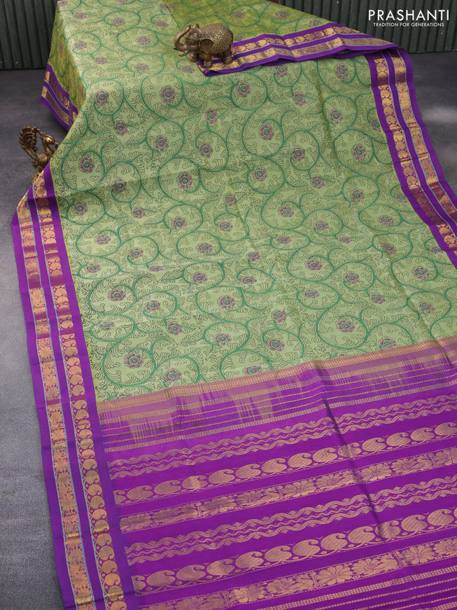 Silk cotton saree pastel green and purple with allover kalamkari prints and rettapet zari woven border