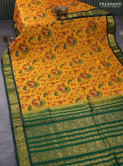 Silk cotton saree mustard yellow and green with allover kalamkari prints and zari woven korvai border