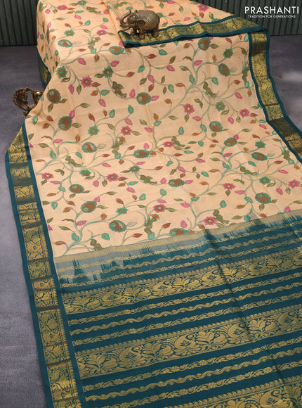 Silk cotton saree pale orange and peacock green with allover kalamkari prints and zari woven korvai border