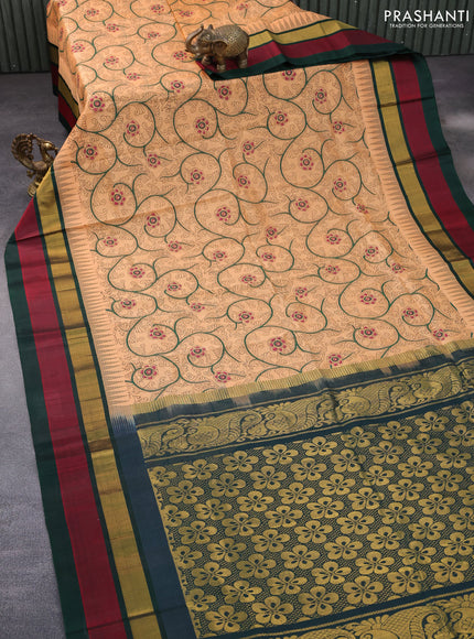 Silk cotton saree pale orange and green with allover kalamkari prints and temple deisgn zari woven simple border