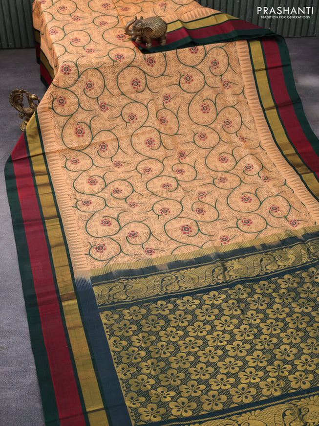 Silk cotton saree pale orange and green with allover kalamkari prints and temple deisgn zari woven simple border