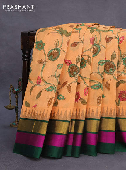 Silk cotton saree pale orange and green with allover kalamkari prints and temple deisgn zari woven simple border