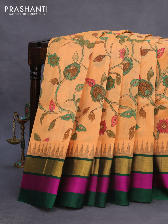 Silk cotton saree pale orange and green with allover kalamkari prints and temple deisgn zari woven simple border