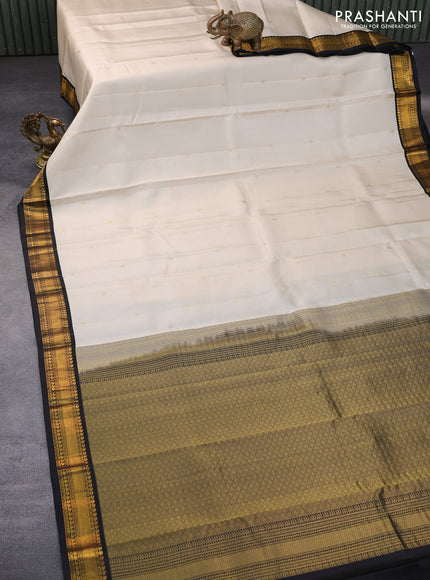 Pure kanchipuram silk saree cream and black with zari woven buttas and zari woven korvai border