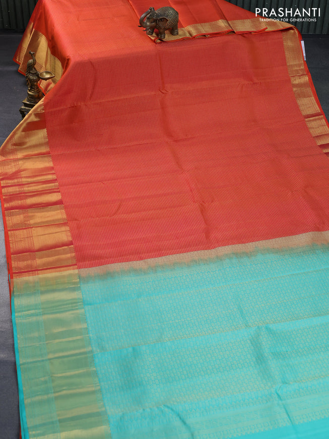 Pure kanchipuram silk saree dual shade of orange and teal blue with allover zari checked pattern and zari woven border