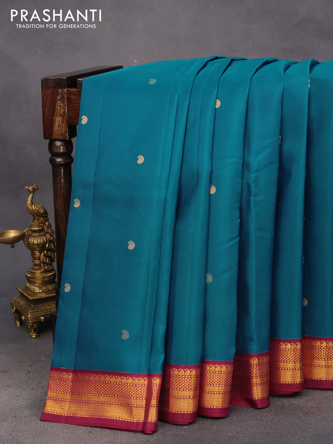 Pure kanchipuram silk saree peacock blue and dark magenta pink with zari woven buttas and zari woven korvai border