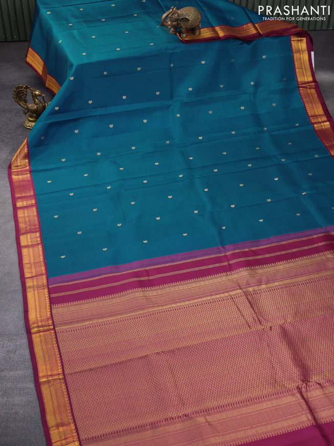 Pure kanchipuram silk saree peacock blue and dark magenta pink with zari woven buttas and zari woven korvai border