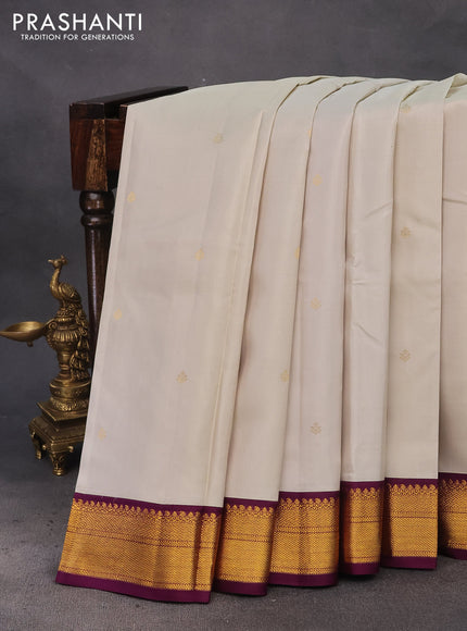 Pure kanchipuram silk saree off white and deep purple with zari woven buttas and zari woven korvai border