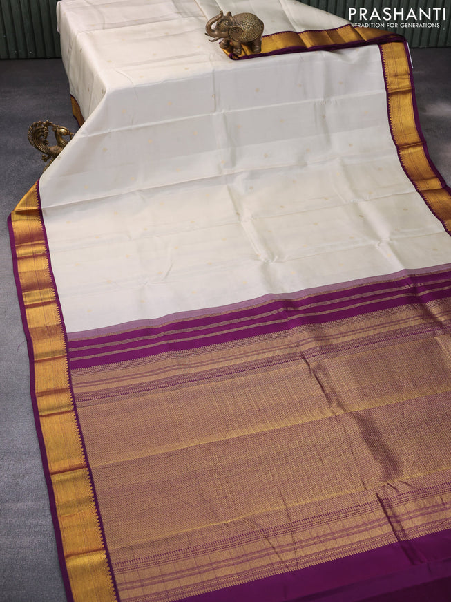 Pure kanchipuram silk saree off white and deep purple with zari woven buttas and zari woven korvai border