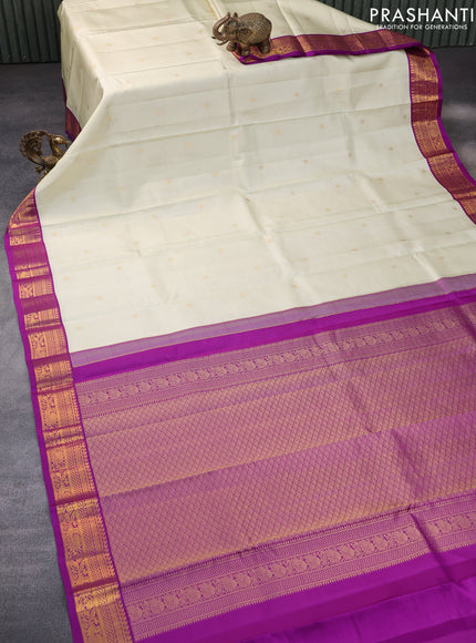 Pure kanchipuram silk saree cream and purple with allover zari weaves & buttas and zari woven korvai border