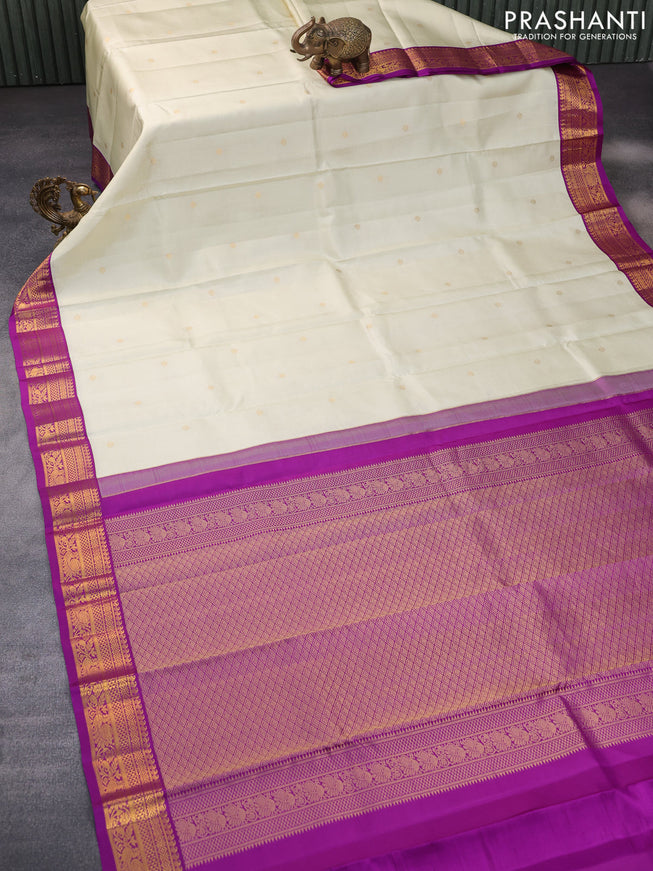 Pure kanchipuram silk saree cream and purple with allover zari weaves & buttas and zari woven korvai border