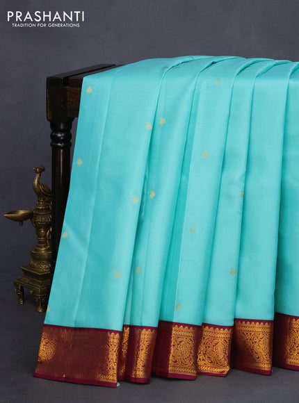 Pure kanchipuram silk saree teal blue and wine shade with zari woven buttas and zari woven korvai border