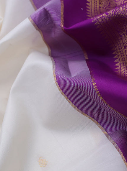 Pure kanchipuram silk saree off white and purple with zari woven buttas and zari woven korvai border