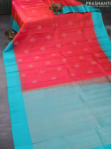 Pure kanchipuram silk saree dual shade of pinkish orange and teal blue with zari woven buttas and simple border