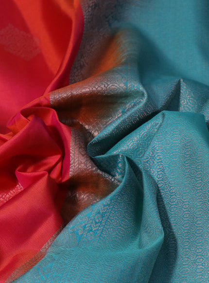 Pure kanchipuram silk saree dual shade of pinkish orange and teal blue with zari woven buttas and simple border