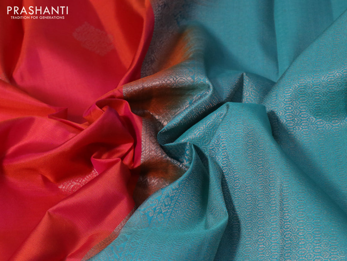 Pure kanchipuram silk saree dual shade of pinkish orange and teal blue with zari woven buttas and simple border