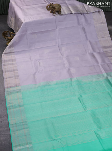 Pure kanchipuram silk saree pastel lavender shade and teal green with silver zari woven buttas and silver zari woven border