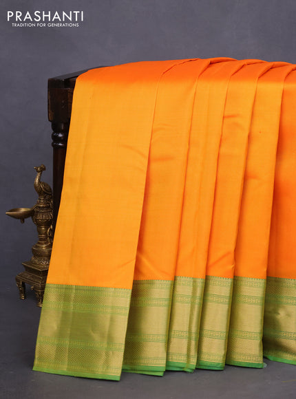 Pure kanchipuram silk saree dual shade of orange and green with plain body and rich zari woven border