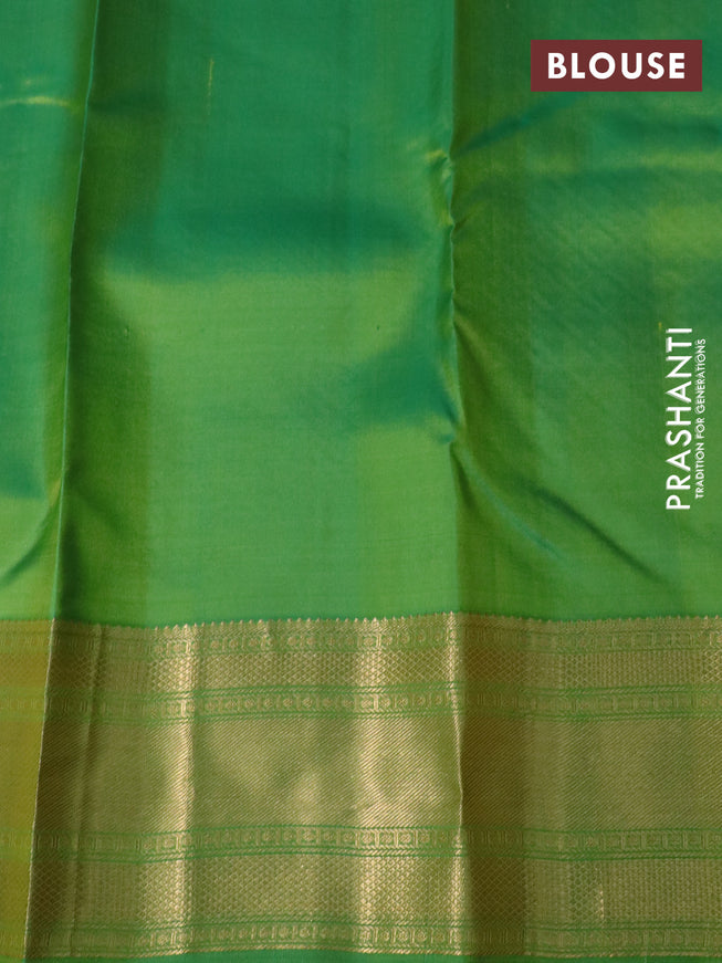 Pure kanchipuram silk saree dual shade of orange and green with plain body and rich zari woven border