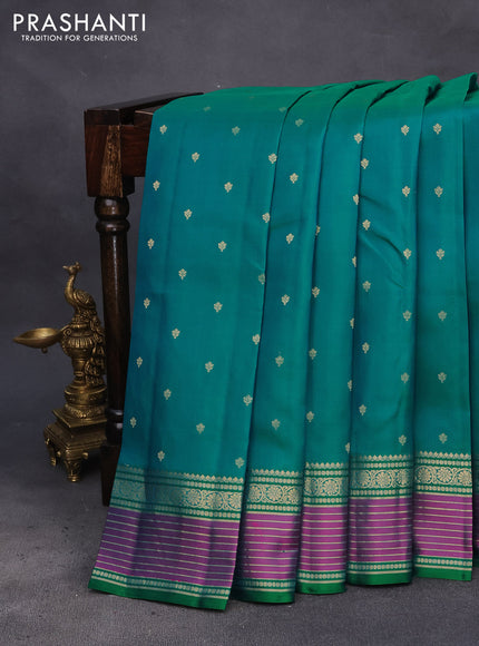 Pure kanchipuram silk saree dual shade of teal bluish green and pink with allover zari woven buttas and rich zari woven border