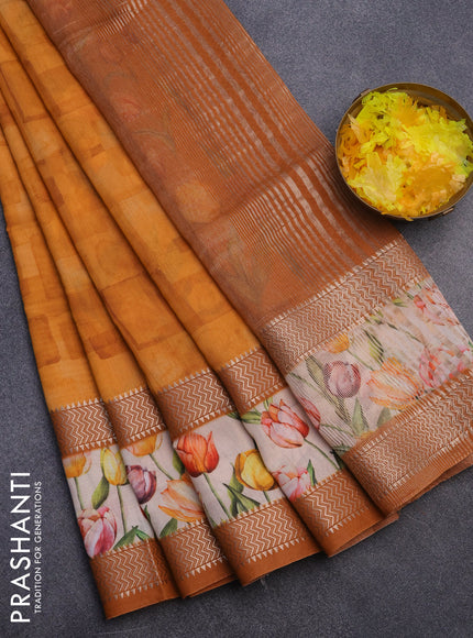 Muslin silk saree orange and cream with allover prints and rettapet zari woven floral printed border