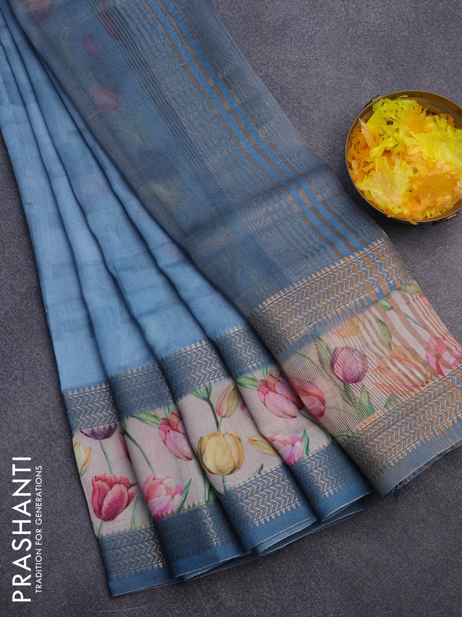 Muslin silk saree light blue shade and cream with allover prints and rettapet zari woven floral printed border